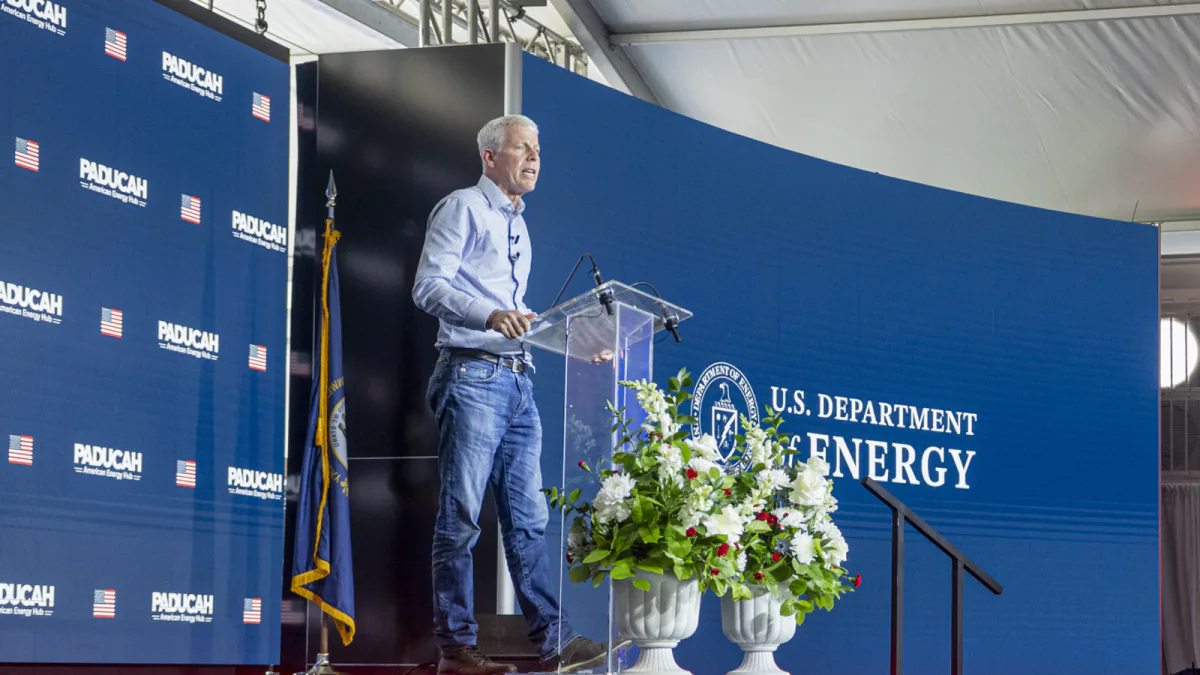U.S. Energy Secretary Chris Wright speaking at a lectern in front of Paducah and Department of Energy backdrops.